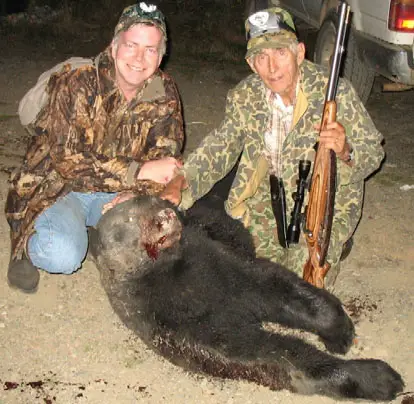 Dad's black bear and Savage 10ML-II rifle.