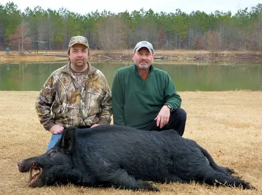 Author and Buddy, Don, pose with Don's 260+ pound boar..