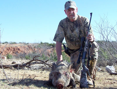 Randy D. Smith with feral hog and Traditions Outfitter.