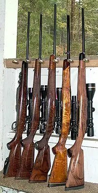 Rack of custom rifles. 7x57 Mauser 98 Custom at far left.